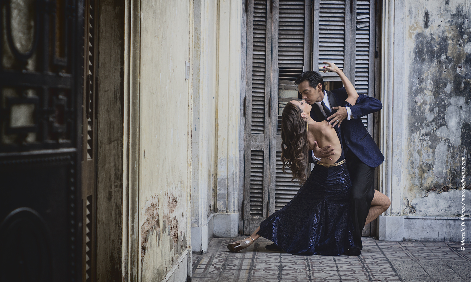 tango dancers in a pose with a buenos aires back drop 