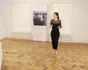 Kim explaining in a tango technique class