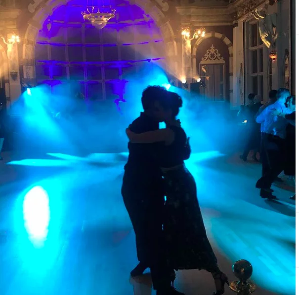 couple dancing tango on an empty dancefloor