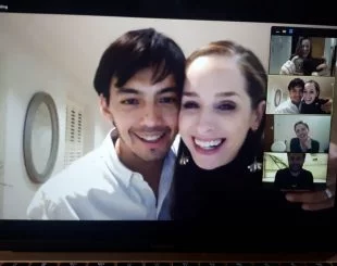 David and Kim smiling at the computer screen