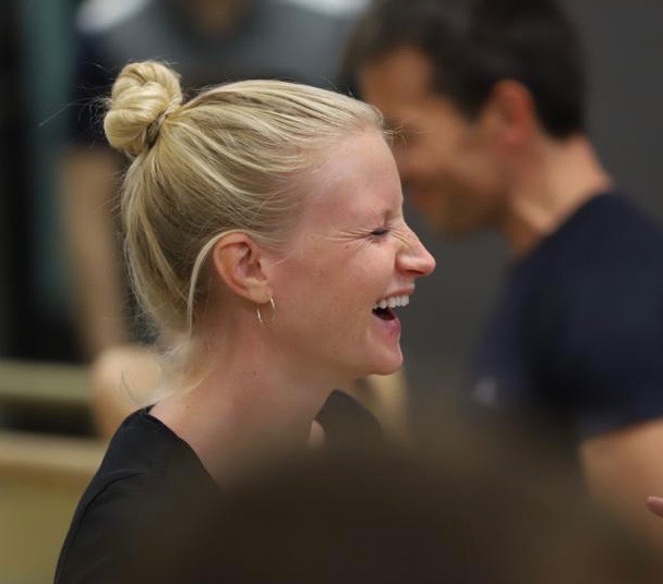 beginner tango student laughing in class