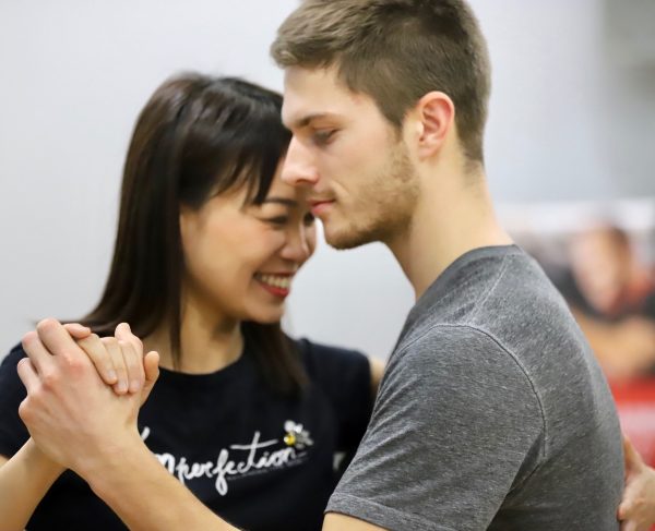 smiling tango students in lesson