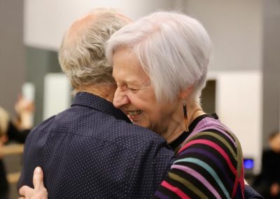 two students laughing and hugging