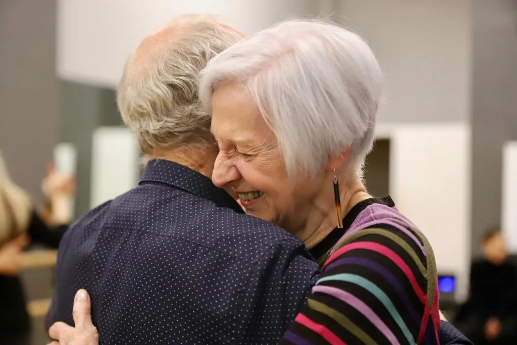two students laughing and hugging