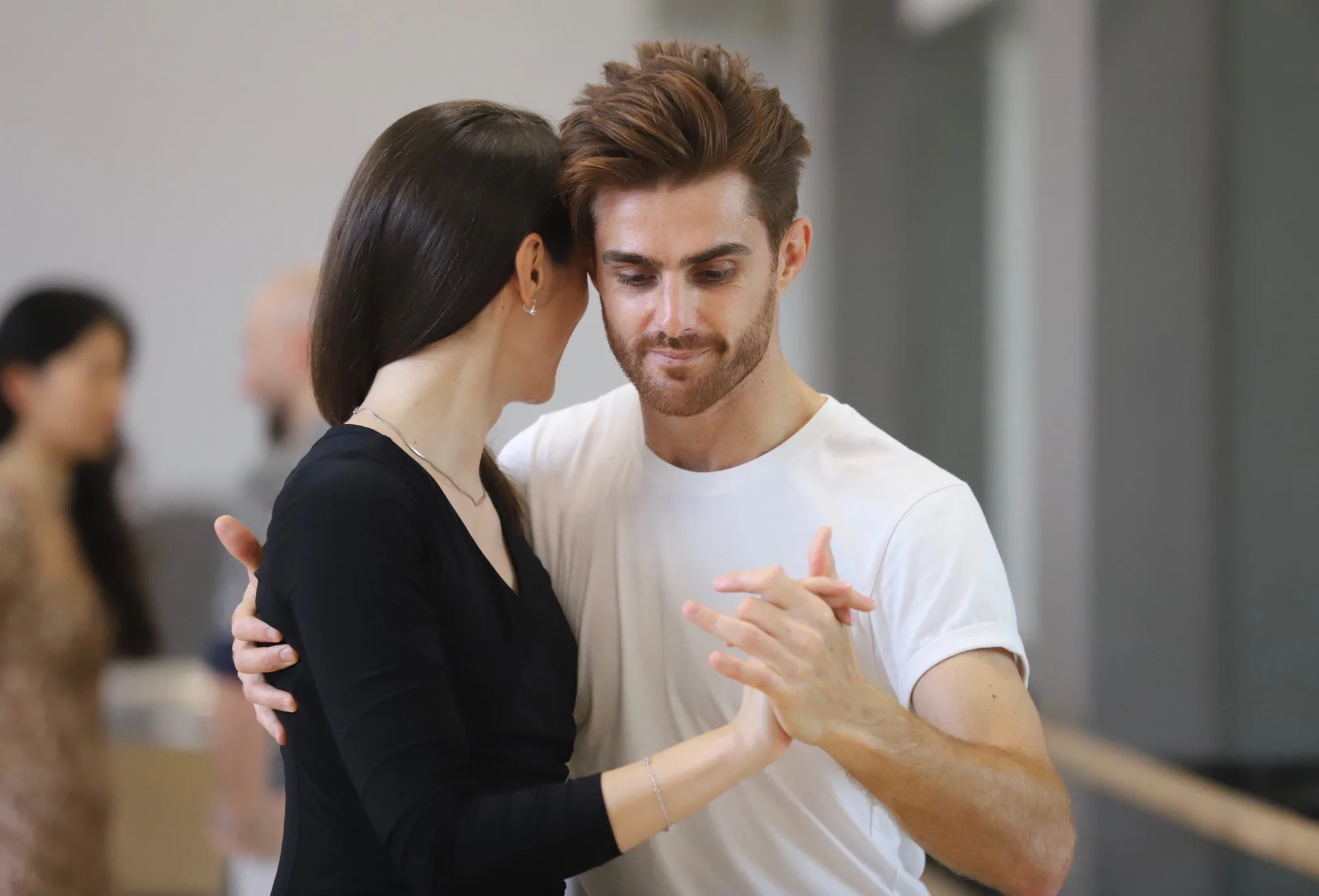 smiling slightly as he embrace his partner